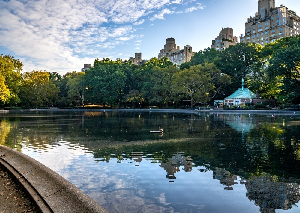 Landscape view of Kerbs Memorial Boathouse on Conservatory Water, a pond located in a natural hollow within Central Park