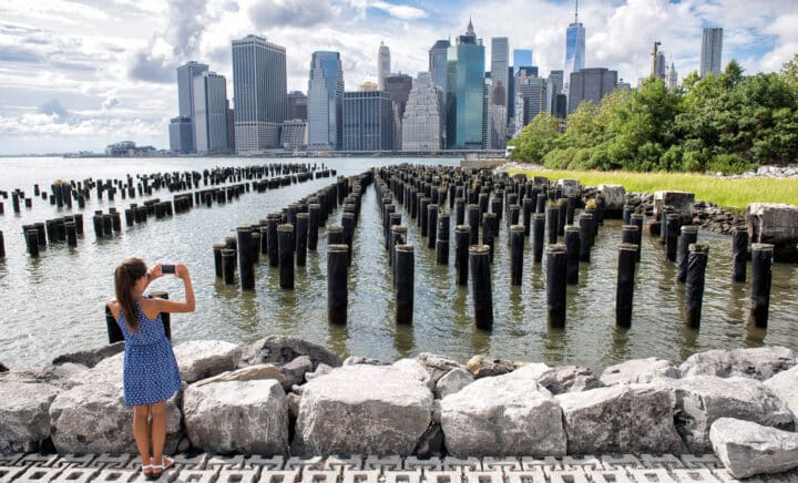 A woman enjoying the view of downtown from the Brooklyn bridge park Pier 1 salt marsh