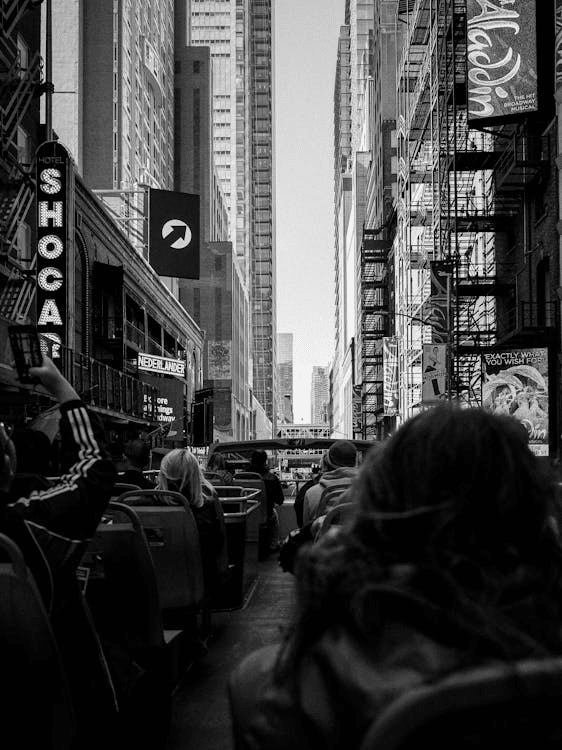 People on a hop-on, hop-off bus touring the NYC