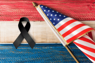 a black mourning ribbon with American flag