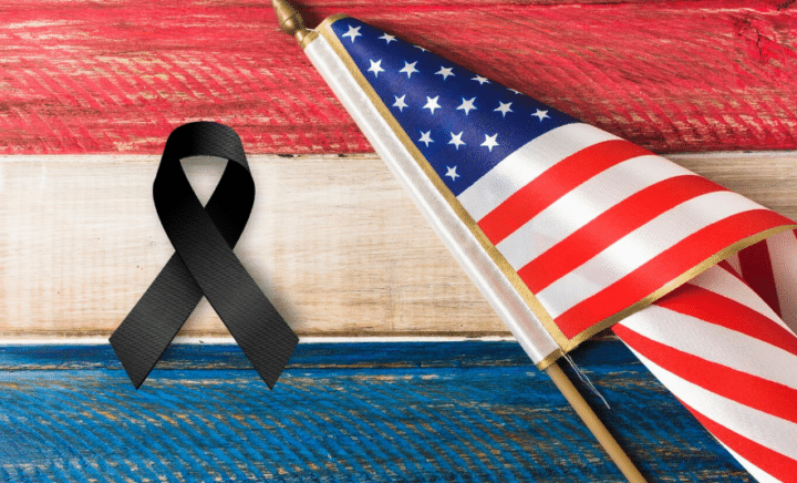 a black mourning ribbon with American flag