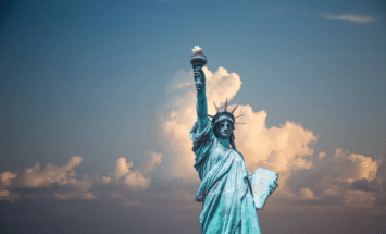 Statue of Liberty with a cloudy sky in the background