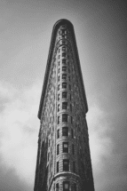 The iconic Flatiron Building in New York City, known for its unique triangular shape.