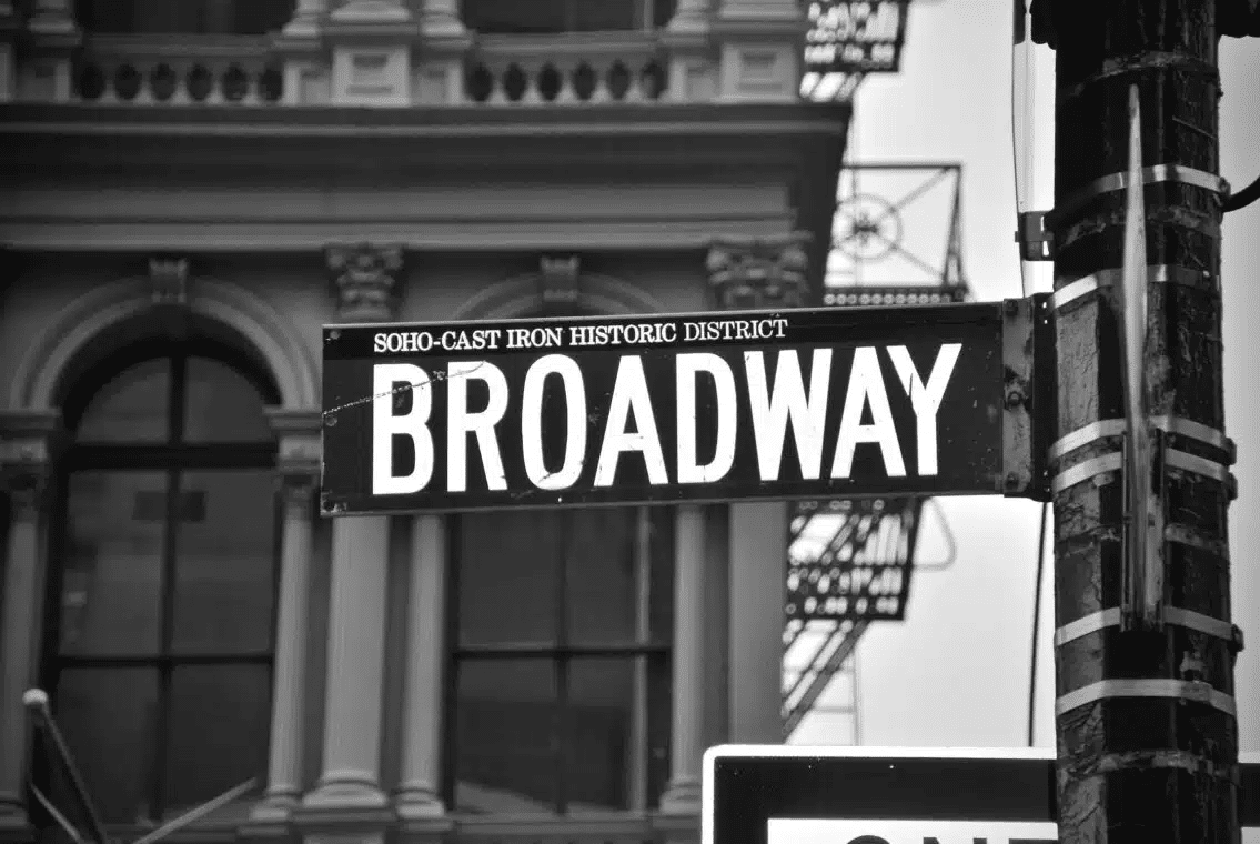 The place where must-see Broadway plays are taking place on a daily basis, a black and white sign reads: SOHO-CAST IRON HISTORIC DISTRICT BROADWAY