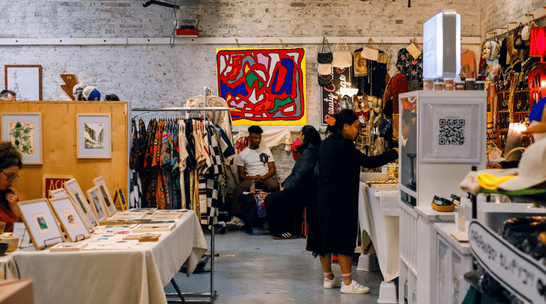 Williamsburg, New York - May 10th 2024: A view of people snapping a bargain flea market vintage second hand shop in Williamsburg - Brooklyn Flea has longe been a top NYC weekend event and they are now launching BQ Flea in October of 2024