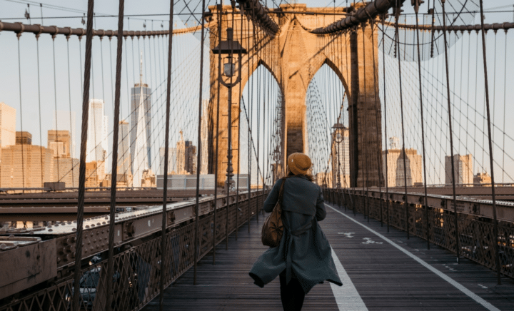 A woman walking on a Brooklyn Bridge