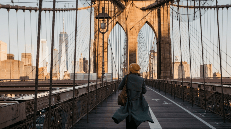 A woman walking on a Brooklyn Bridge