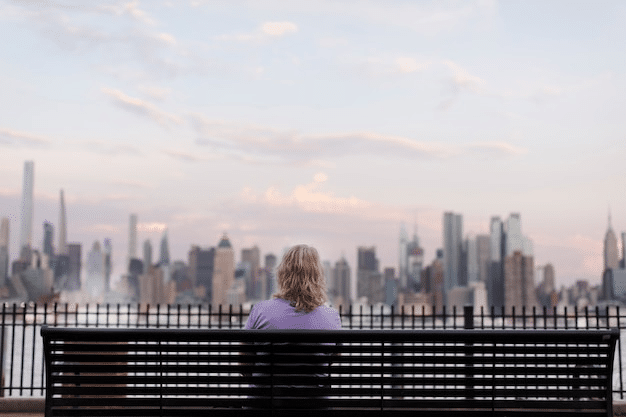 woman sitting at a bench soaking in the views using NYC travel guide