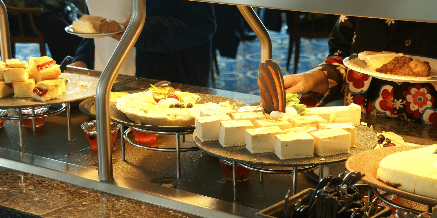 A buffet of various deserts set on a table showing what a NYC dinner cruise may offer