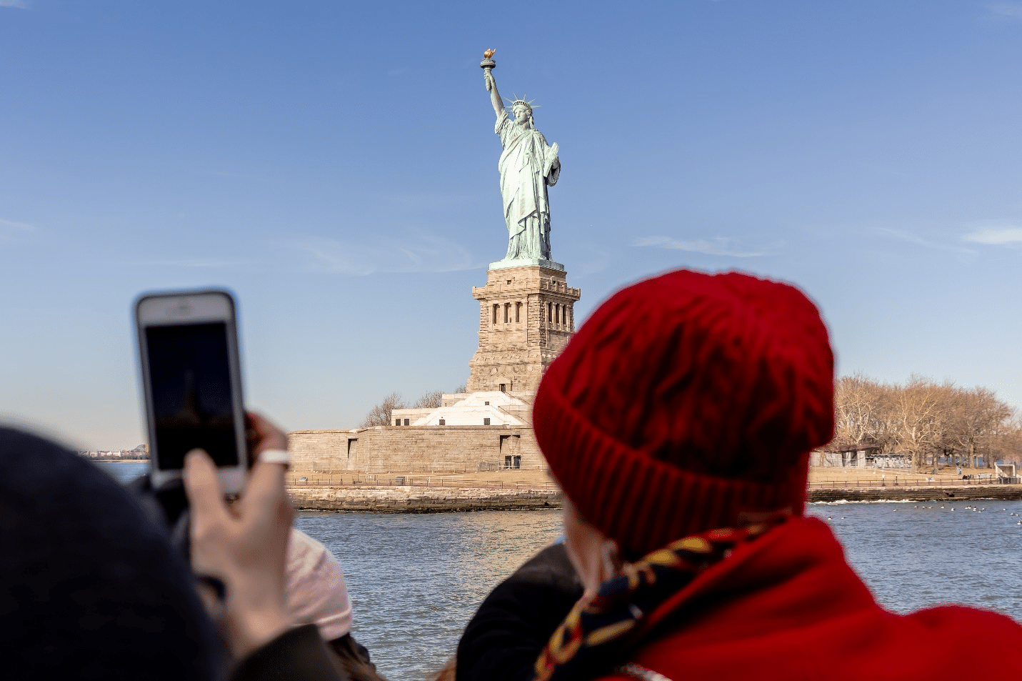 People looking at the Statue of Liberty during a one-day sightseeing tour