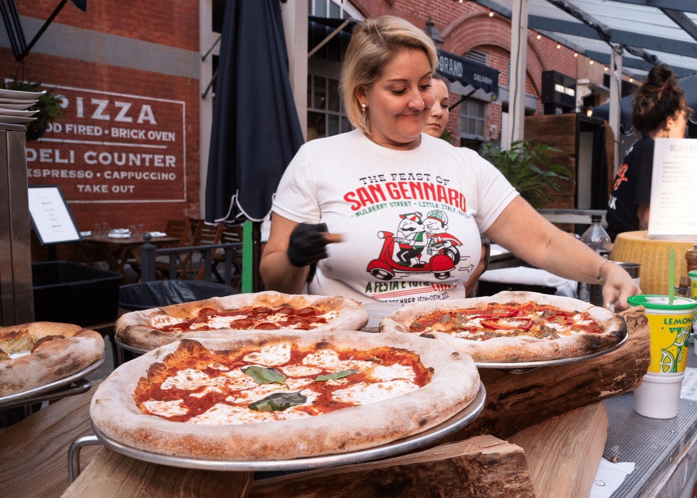 A woman with pizzas