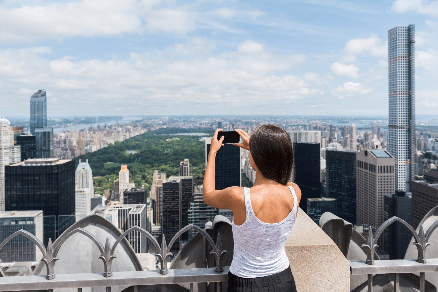 A woman at the Top of the Rock Observation Deck during a city trip to New York