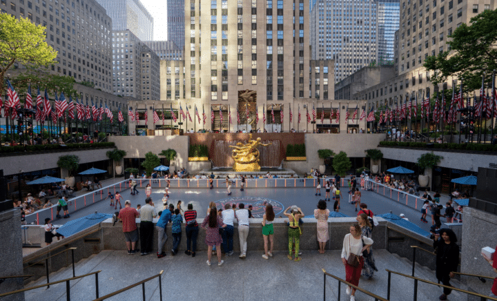 People standing around an ice-skating rink during a New York City travel guide