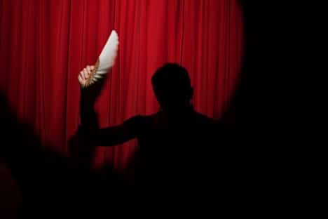 The silhouette of a Broadway performer on stage