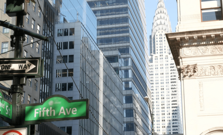 A signboard for Fifth Avenue seen during a New York City travel guide