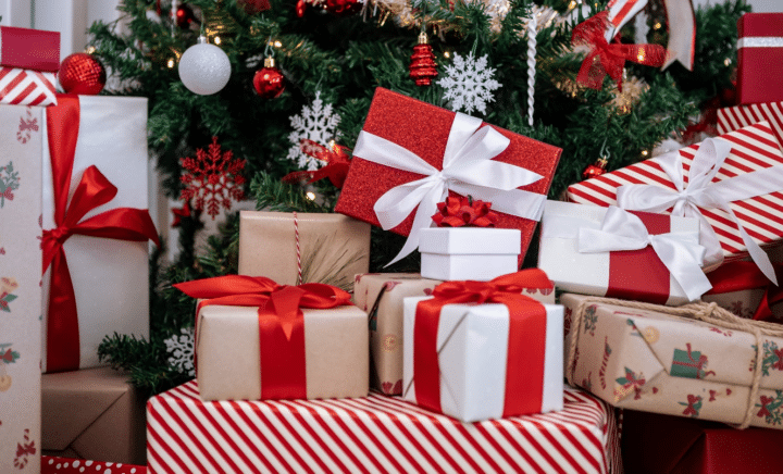 Presents in front of a Christmas tree seen during a New York City travel guide