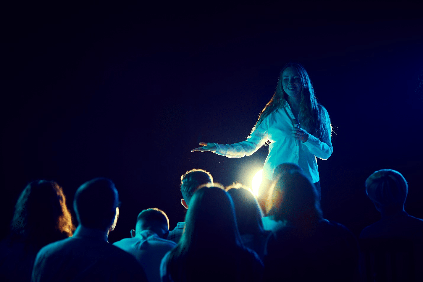 A woman on a stage during a one-day sightseeing tour