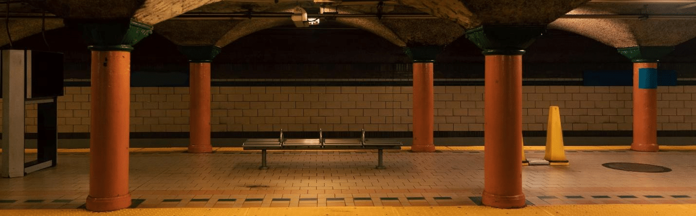 An empty subway station with orange pillars seen during a one-day sightseeing tour