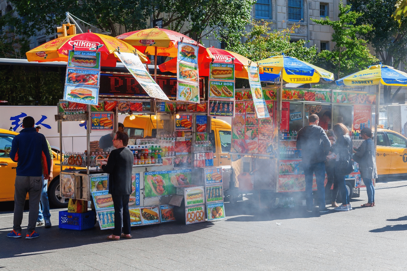 Customers standing outside food carts in NYC