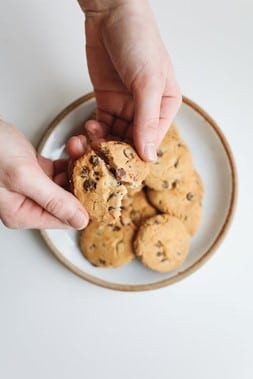 A person breaking a cookie during a one-day sightseeing tour