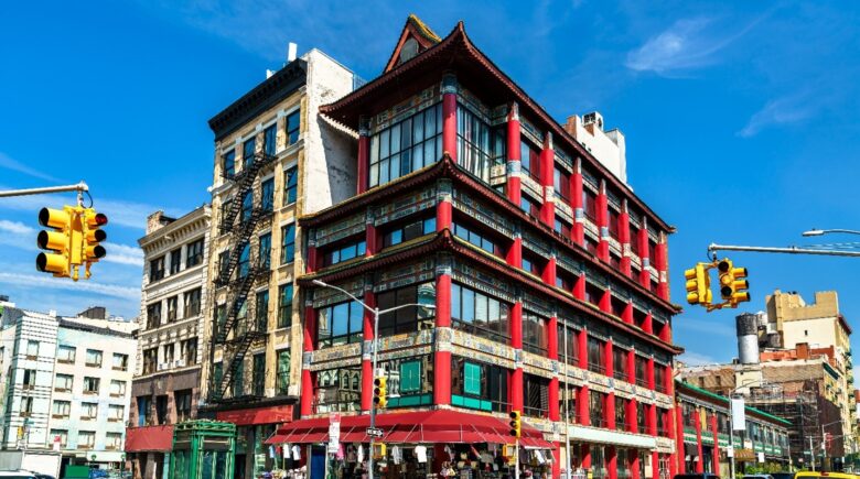 A large red building in Chinatown seen during a New York City travel guide