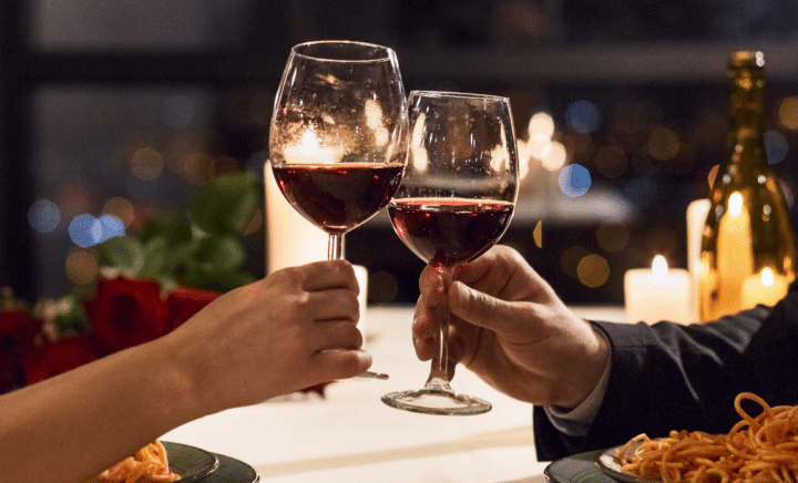 People clinking their wine glasses during aNew York City travel guide