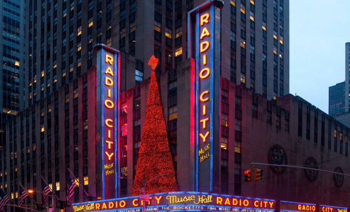 Neon signs for Radio City Hall seen during a New York City travel guide