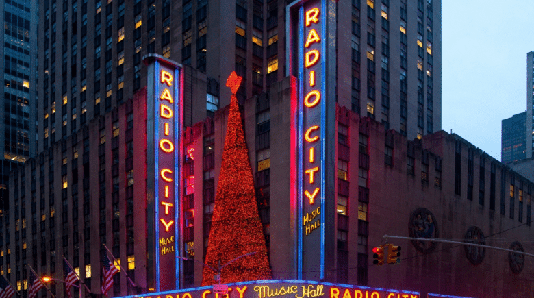 Neon signs for Radio City Hall seen during a New York City travel guide