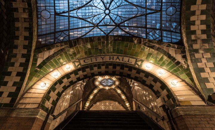 An arched entrance to City Hall seen during a New York City travel guide