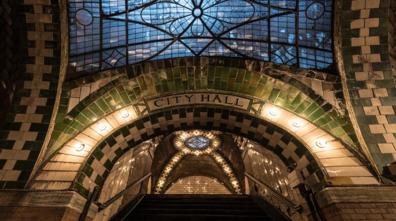 An arched entrance to City Hall seen during a New York City travel guide