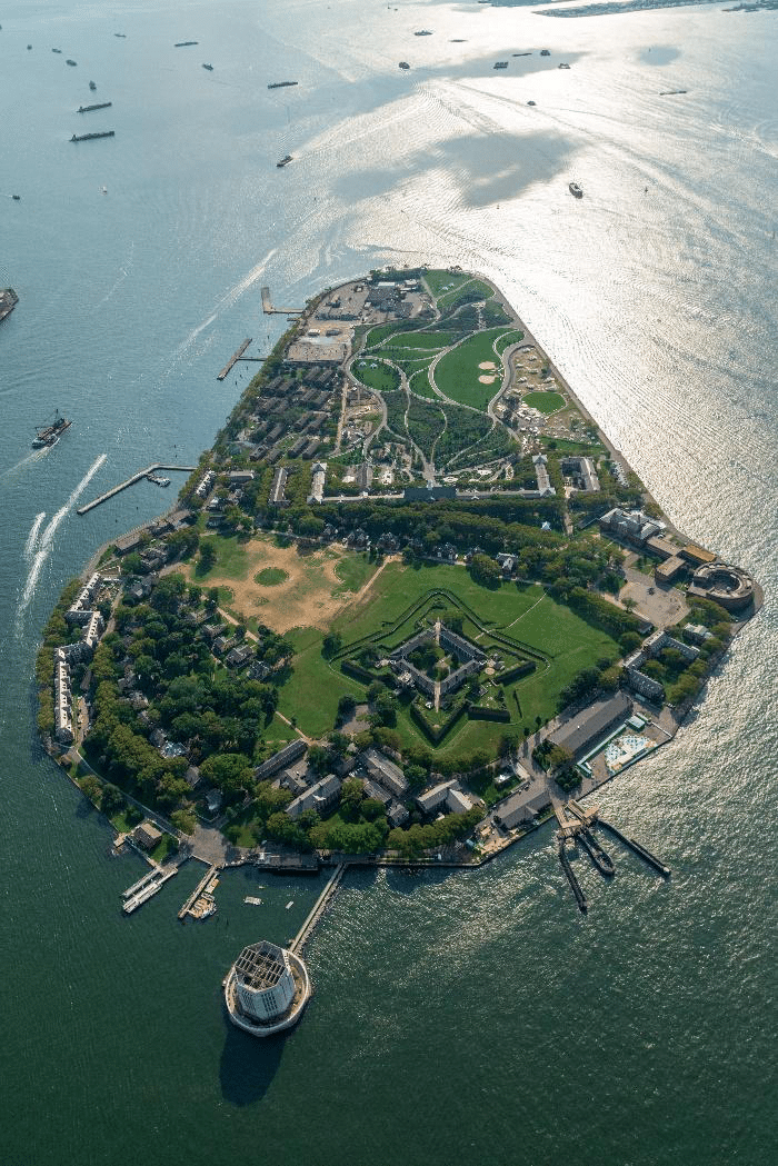 erial view of Governors Island, showcasing lush green spaces and waterfront views of Manhattan.