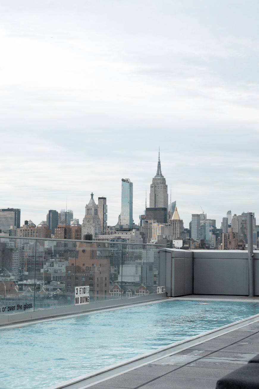 A pool on the rooftop of a luxury NYC hotel