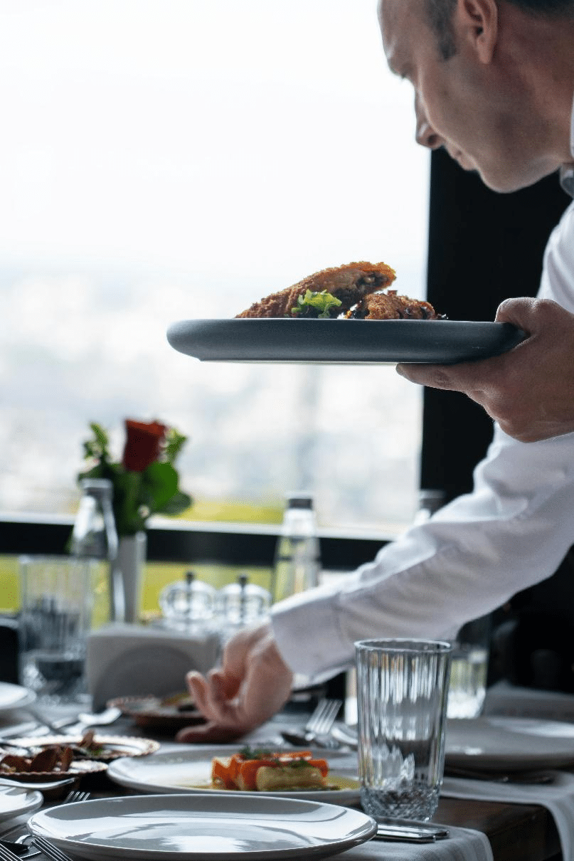 A picture of a person serving food on a table
