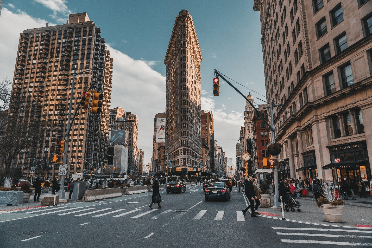 A busy street in front of a building seen during a New York City travel guide