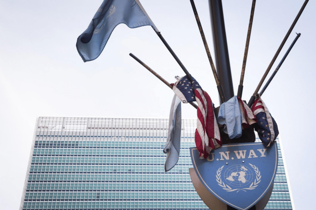 A flag and a shield with a building in the background seen during a one-day sightseeing tour