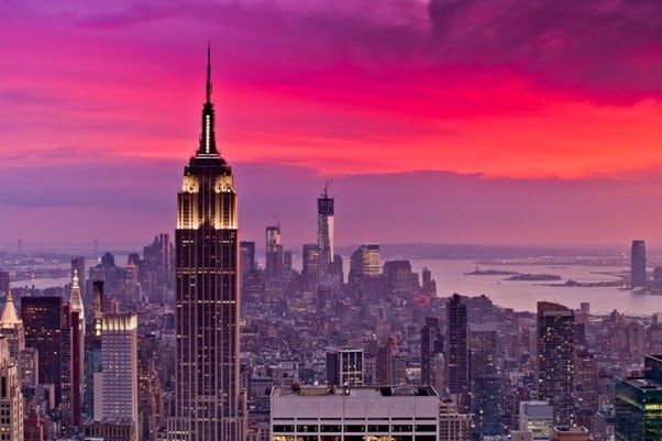 A breathtaking view of the New York City skyline at sunset, featuring iconic skyscrapers.