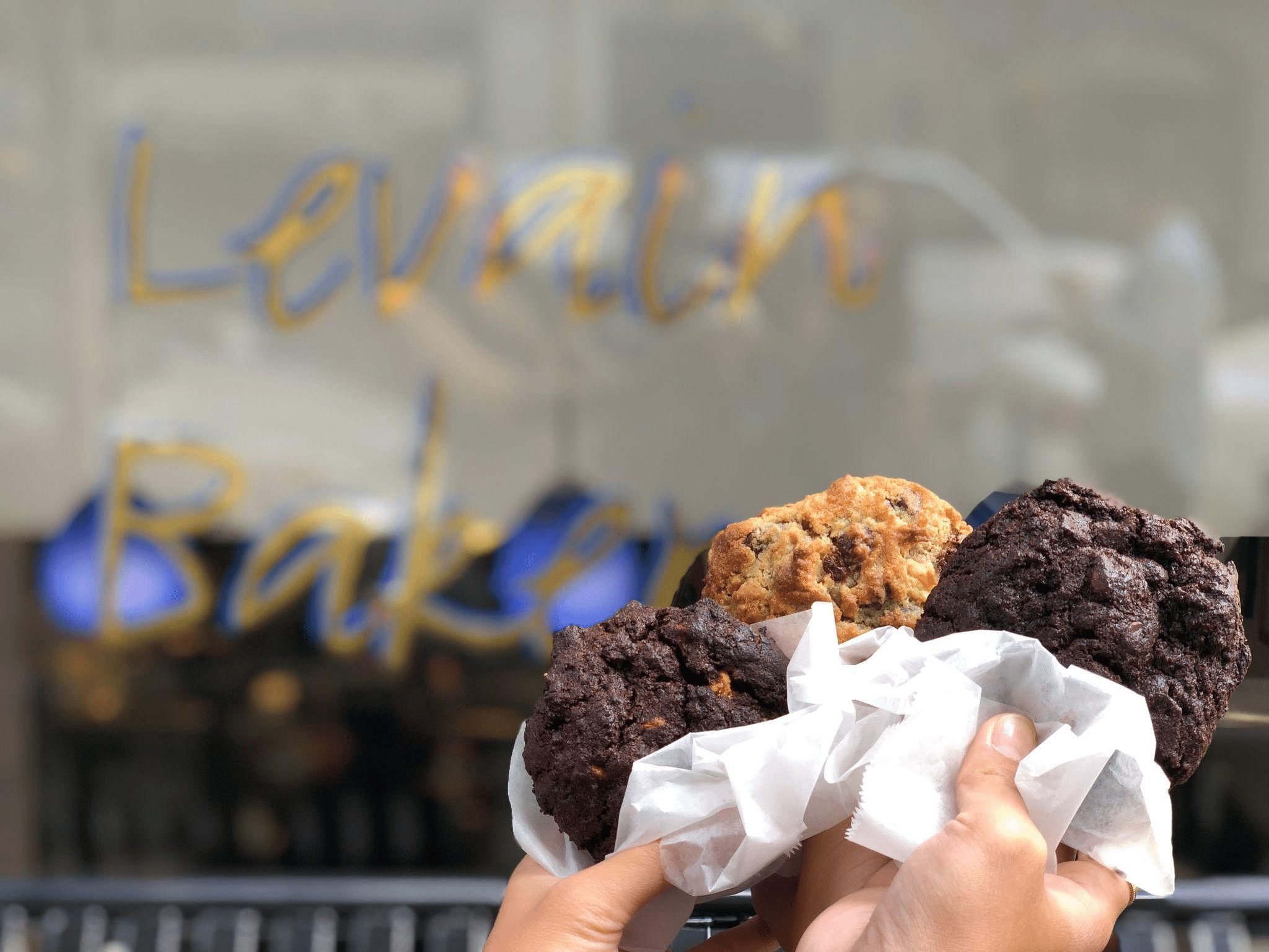 People holding Levain Cookies.