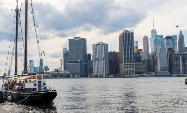 Boat with NYC in the back duringaNew York City travel guide