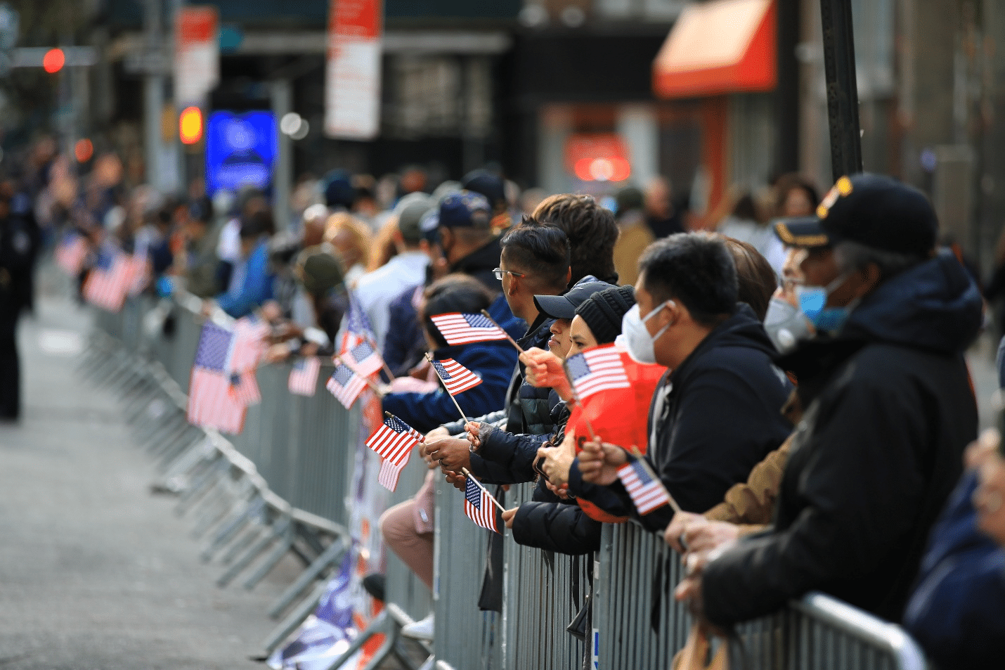 A group of people holding American flags during New York City travel guide