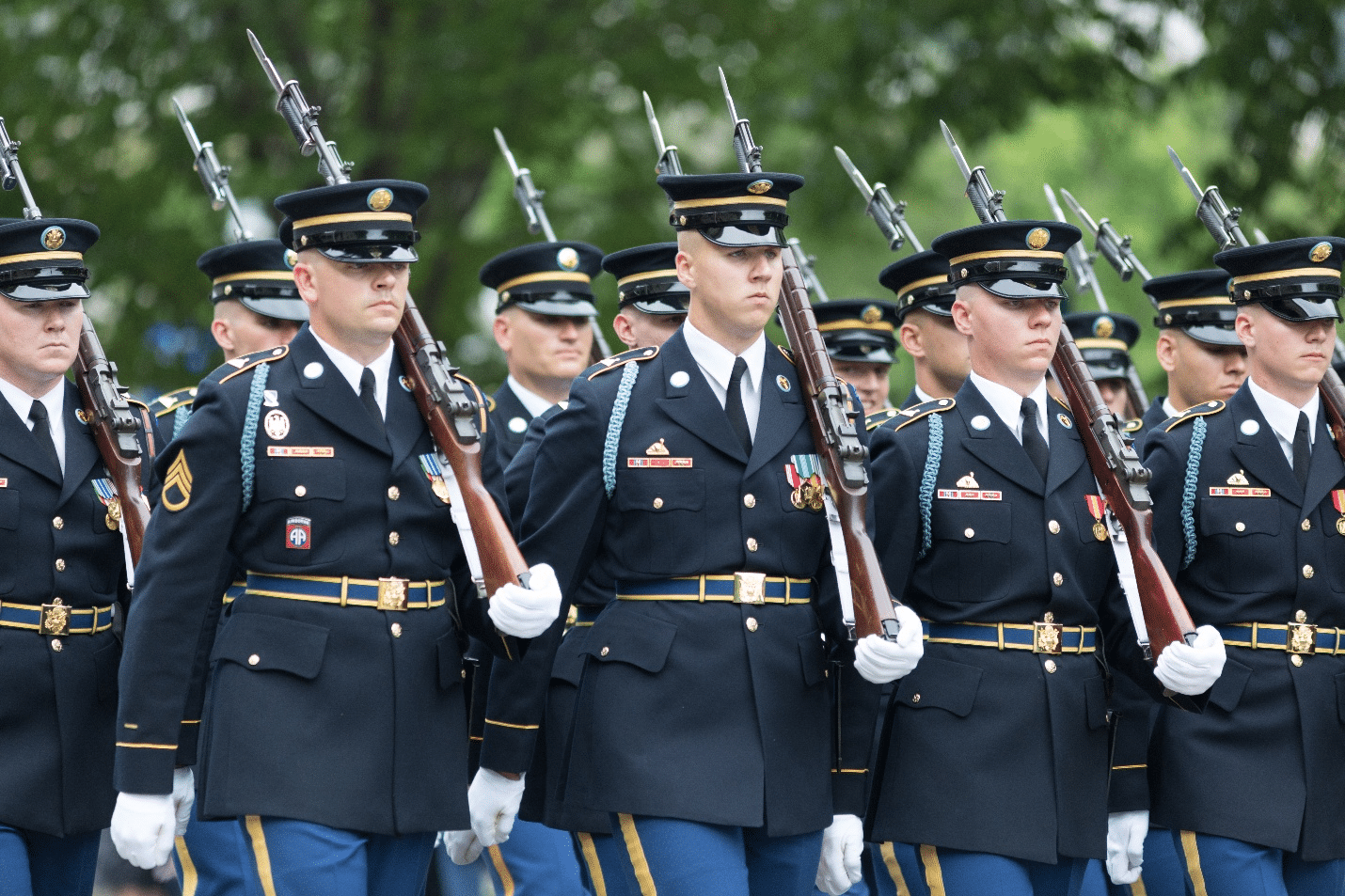 Soldiers marching with guns at a parade during a one-day sightseeing tour