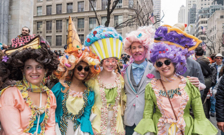 Crowd celebrating at the NYC Easter Parade with festive bonnets and outfits.