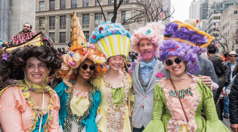 Crowd celebrating at the NYC Easter Parade with festive bonnets and outfits.