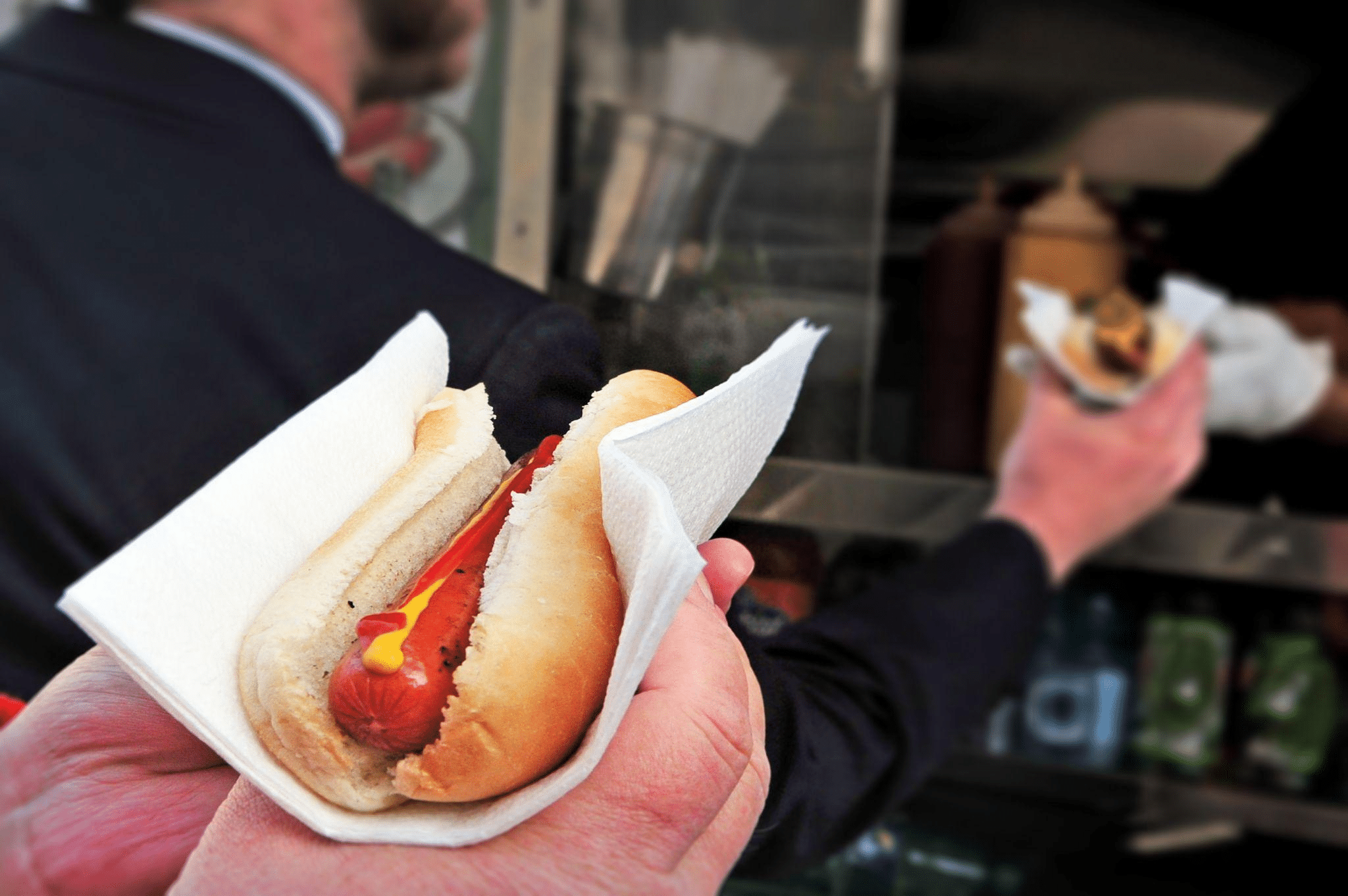 Street vendor serving hot dogs
