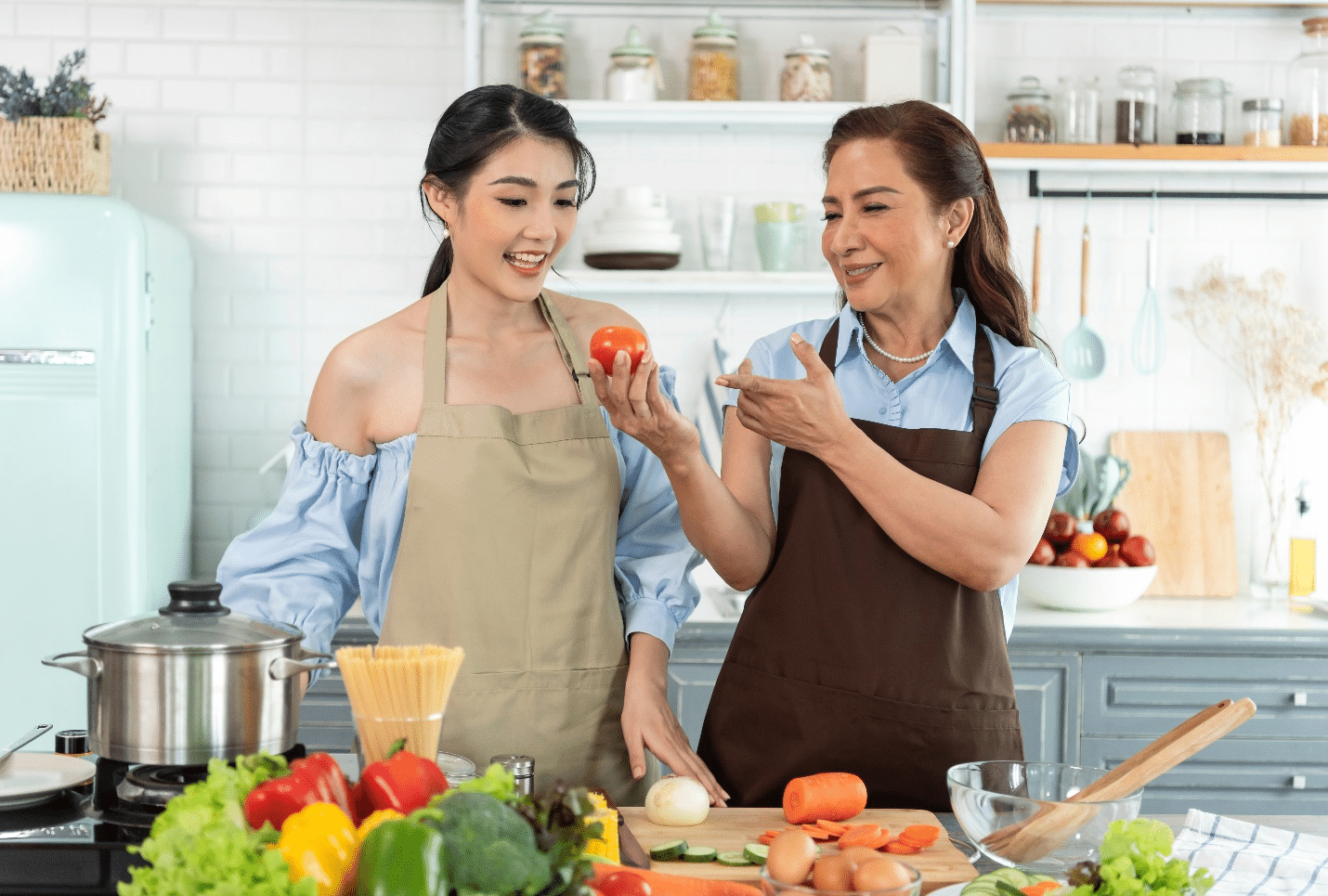 Two women cooking together during a New York City travel guide
