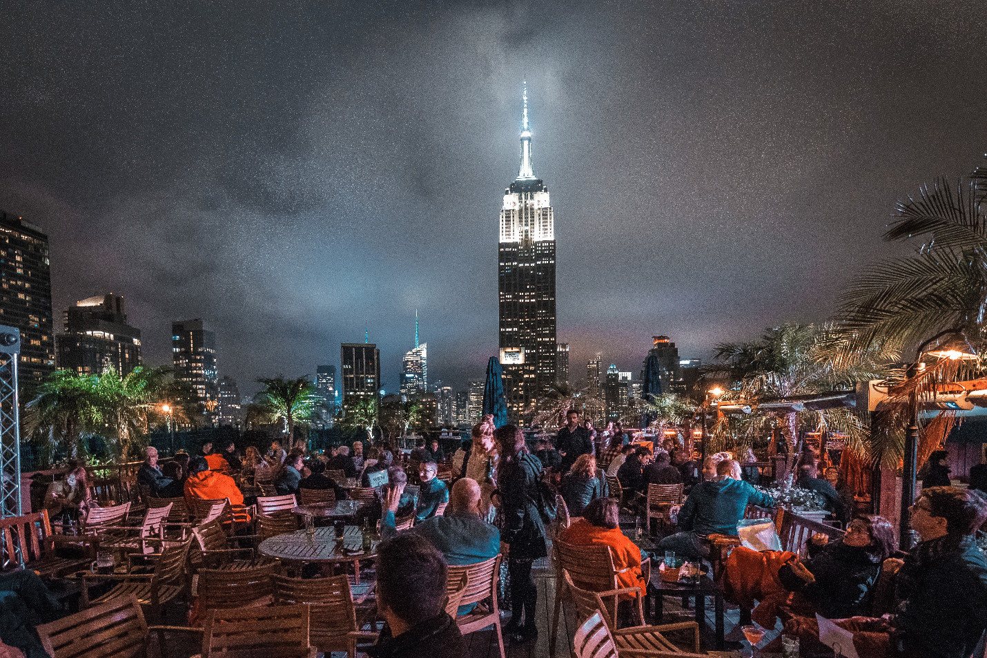 People at a rooftop bar during a city trip to New York