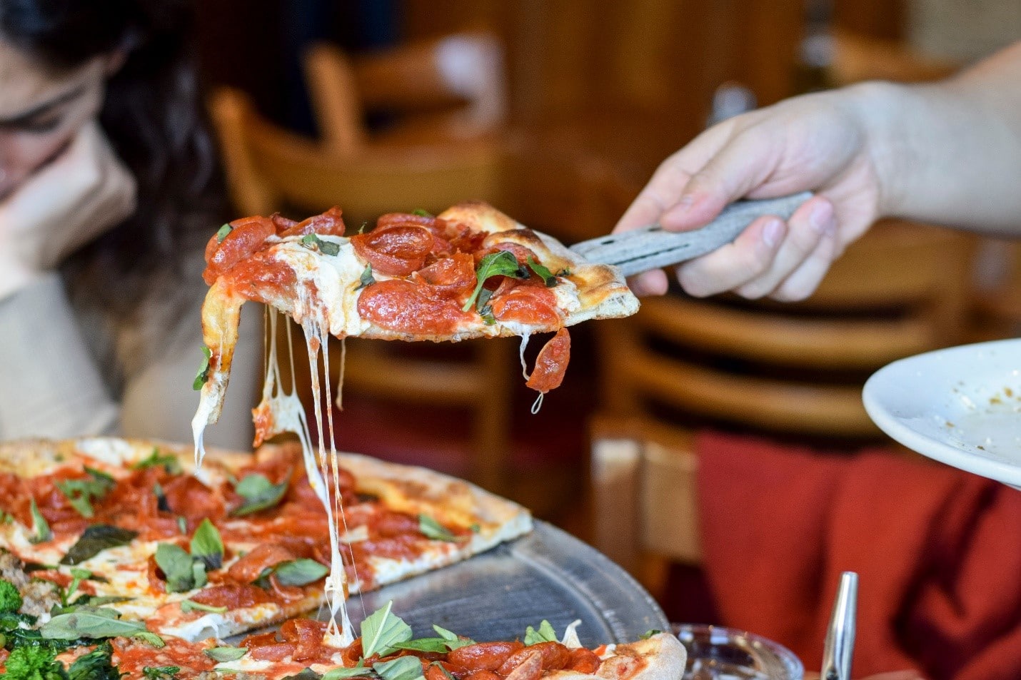 Cheese dripping from a slice of pizza during aone-day sightseeing tour