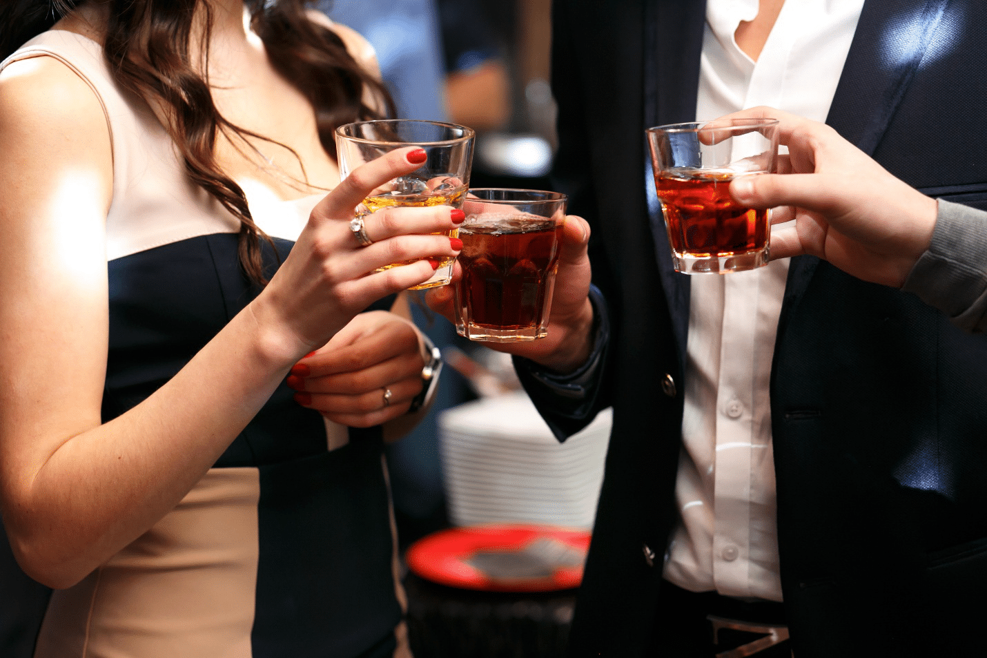 A man and woman holding drinks during a New York City travel guide