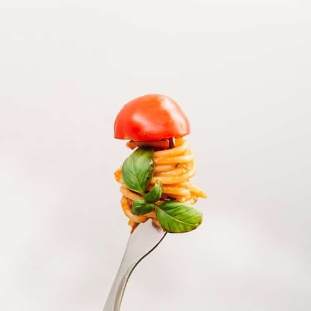 A forkful of pasta eaten duringa New York City travel guide