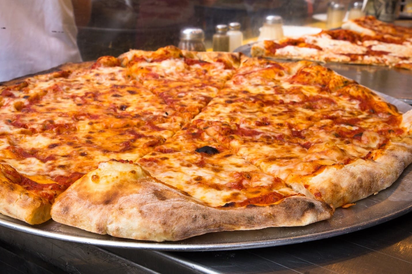 A large cheese pizza seen during a New York City travel guide