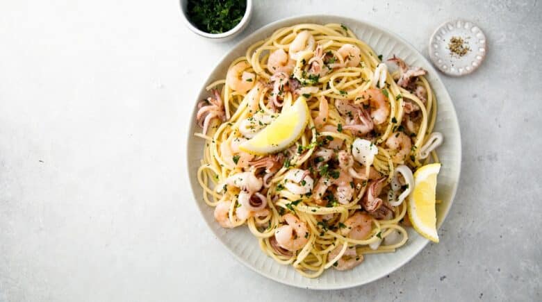 A plate of seafood pasta seen during a New York City travel guide